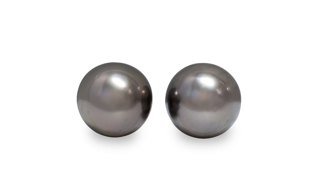 A round shape Tahitian pearl pair is displayed on a white background.