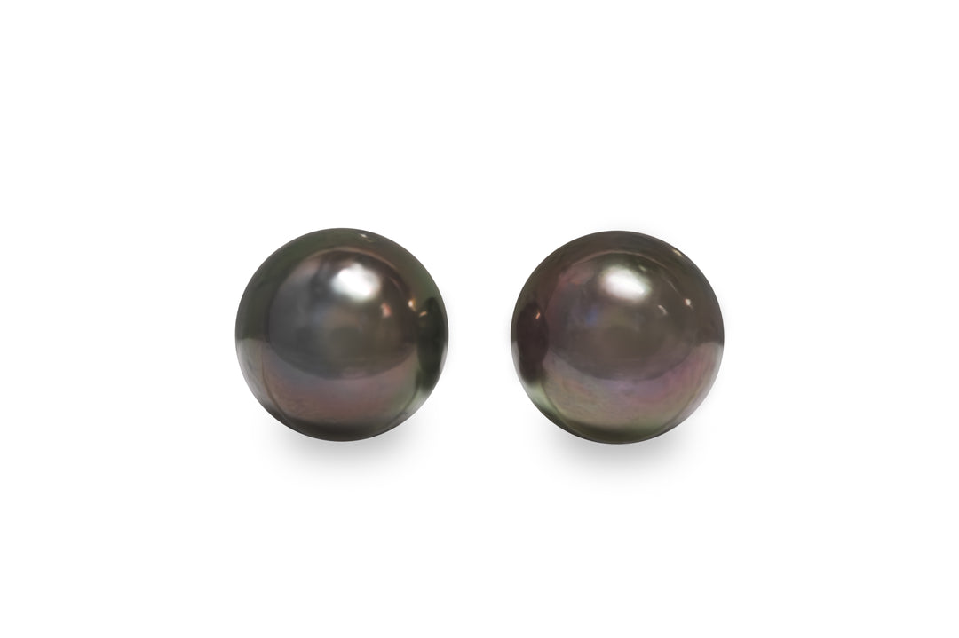 A round shape Tahitian pearl pair is displayed on a white background.