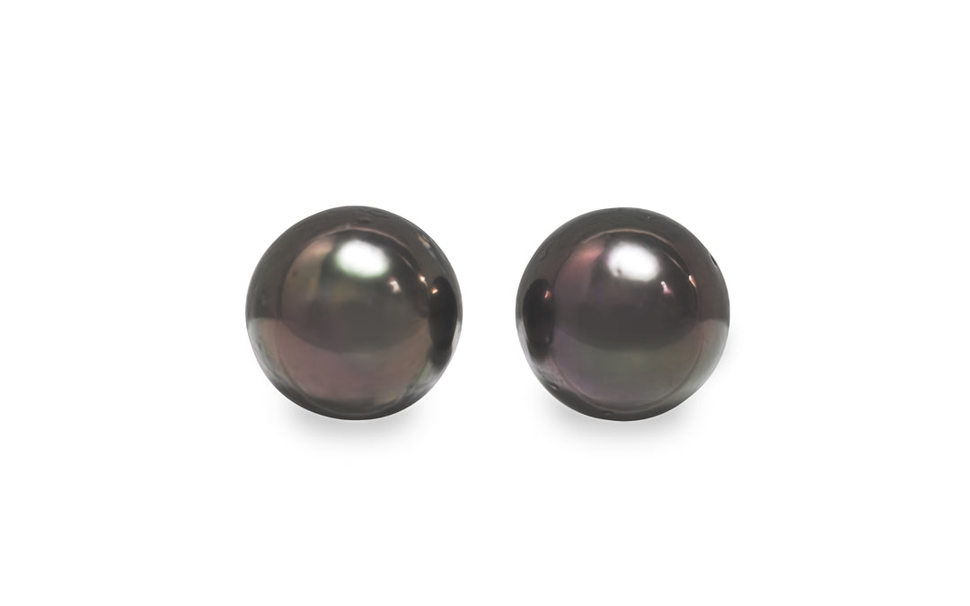 A round shape Tahitian pearl pair is displayed on a white background.
