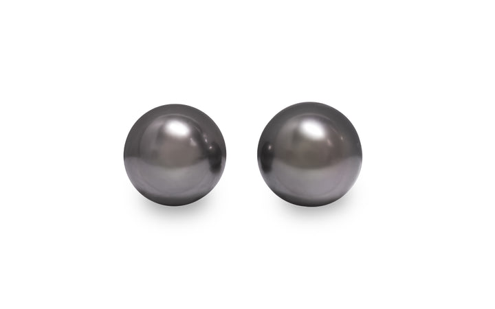 A round shape Tahitian pearl pair is displayed on a white background.
