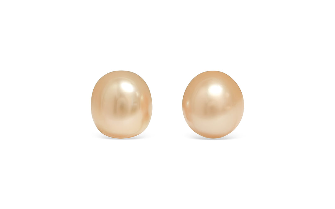 A semi baroque deep light Golden South Sea pearl pair is displayed on a white background.