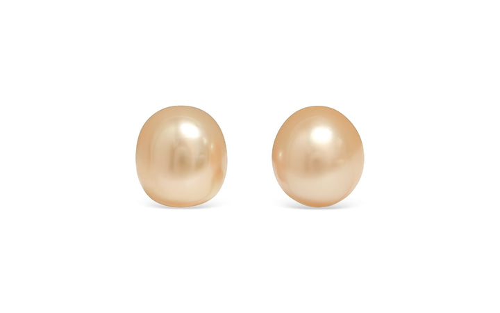 A semi baroque deep light Golden South Sea pearl pair is displayed on a white background.