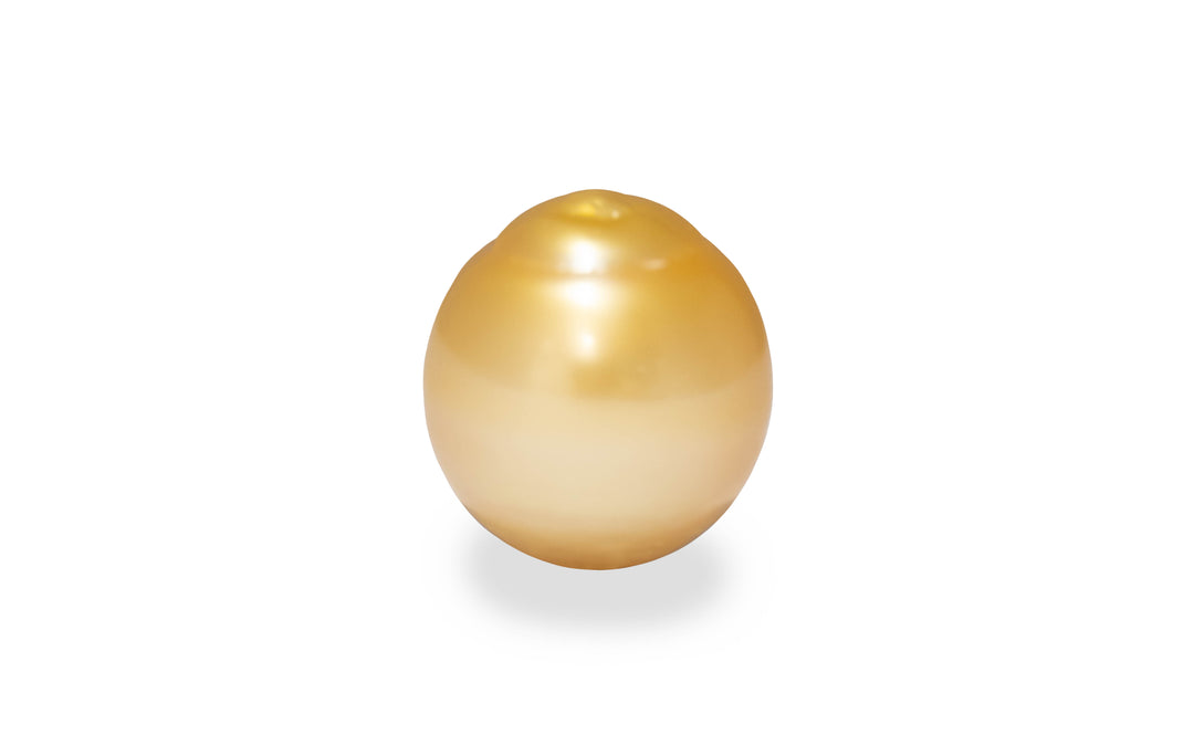 A semi baroque shape gold South sea pearl is displayed on a white background.