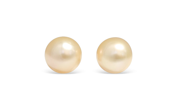 A semi round light Golden South Sea pearl pair is displayed on a white background.
