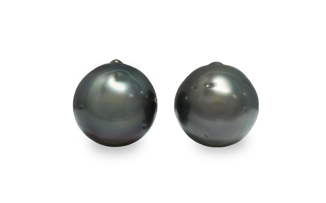 A semi round Tahitian pearl pair is displayed on a white background.