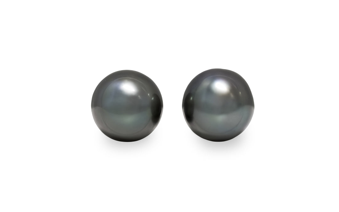 A semi round shape Tahitian pearl pair is displayed on a white background.
