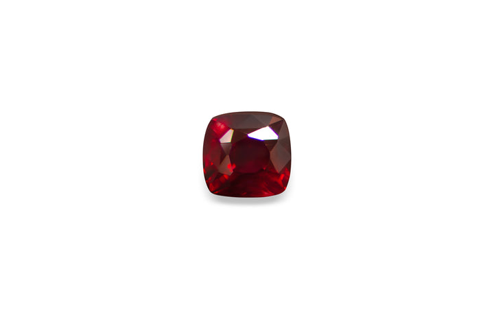 A square cushion cut Mozambique ruby gemstone is displayed on a white background.