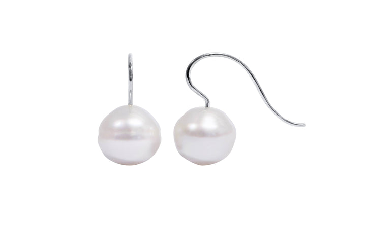 A pair of 18K white gold circle pink white 13.2mm south sea pearl shepherd hook earrings is displayed on a white background.