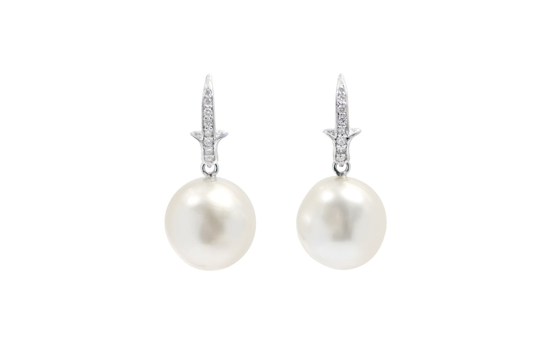 A pair of White South Sea pearl diamond  shepherd hook earrings in 18k white gold is displayed on a white background.