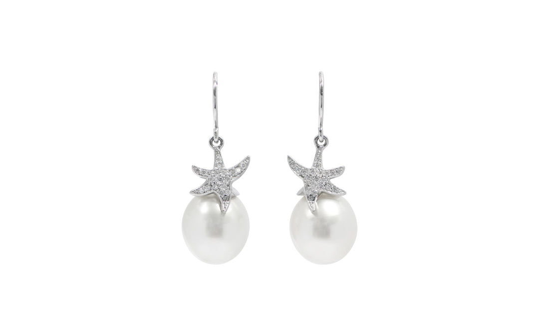 A pair of White South Sea pearl diamond starfish shepherd hook earrings in 18k white gold is displayed on a white background.