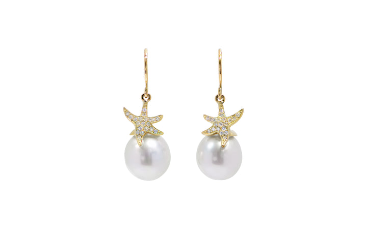 A pair of White South Sea pearl diamond starfish shepherd hook earrings in 18k yellow gold is displayed on a white background.
