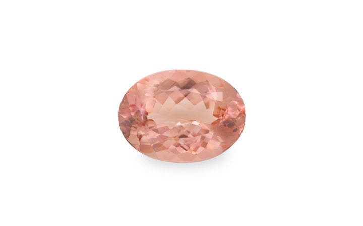 An oval cut peach morganite gemstone is displayed on a white background.