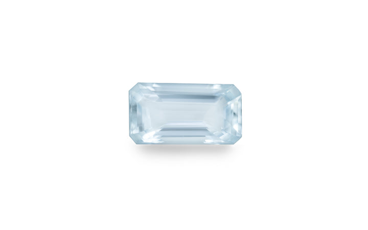 An emerald cut aquamarine gemstone is displayed on a white background. 