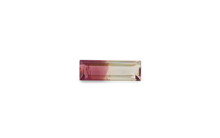 A baguette cut bi-colour pink and yellow tourmaline gemstone is displayed on a white background.
