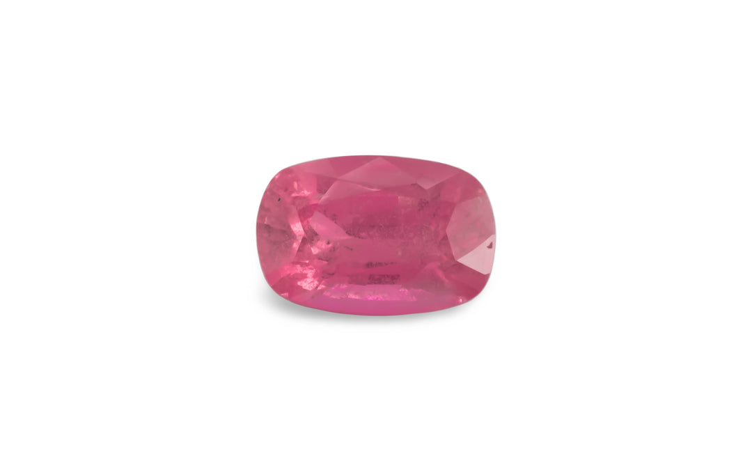 A cushion cut pink sapphire gemstone is displayed on a white background.