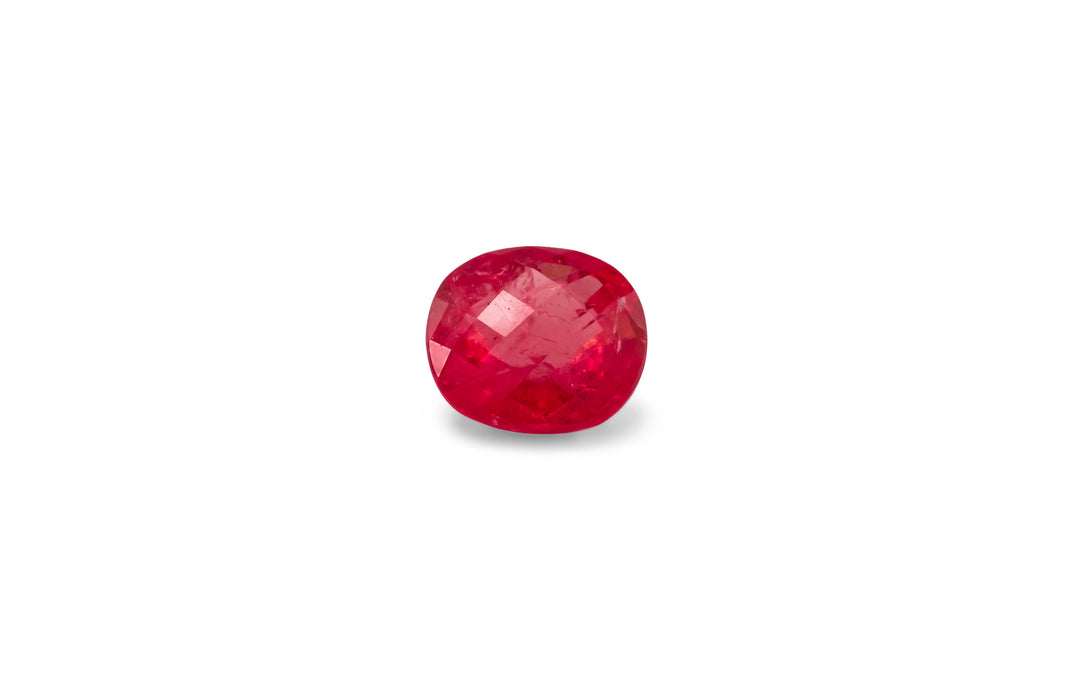 A cushion cut, red Ceylon sapphire gemstone is displayed on a white background.