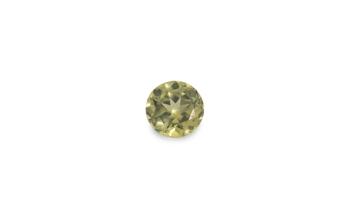A round brilliant cut, green Australian sapphire gemstone is displayed on a white background.