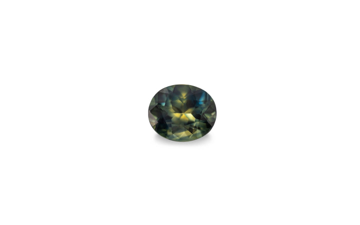 An oval cut green blue yellow Australian sapphire gemstone is displayed on a white background.