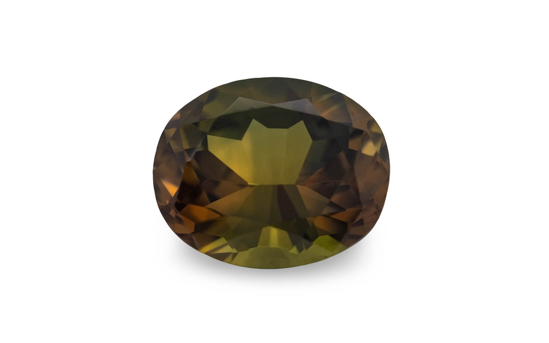An oval cut green brown Australian sapphire gemstone is displayed on a white background.
