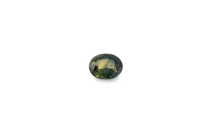  An oval cut green yellow Australian sapphire gemstone is displayed on a white background.