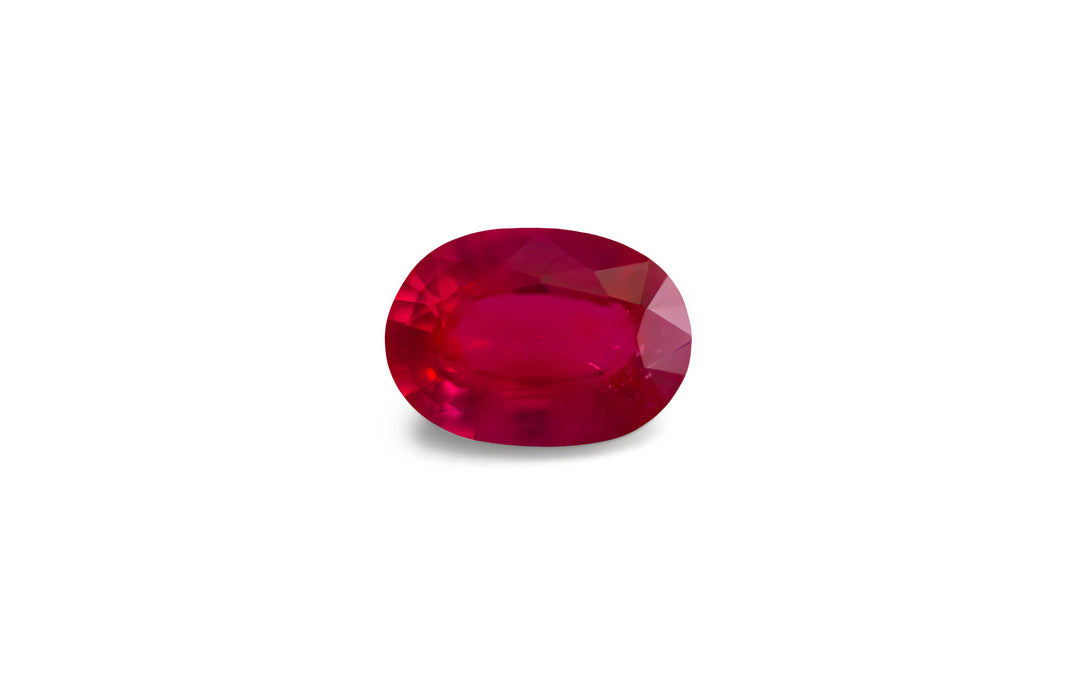 An oval cut natural Burmese red ruby gemstone is displayed on a white background.