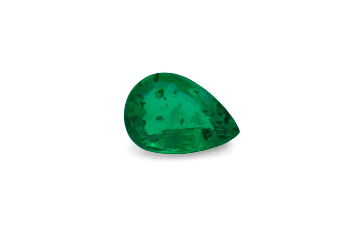 A pear cut green African emerald gemstone is displayed on a white background.