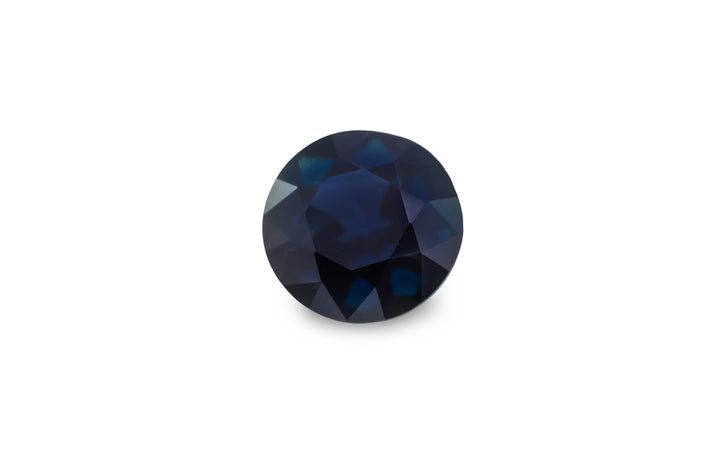 A round brilliant cut blue Australian sapphire gemstone is displayed on a white background.