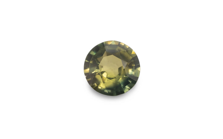 A round brilliant cut green Australian sapphire gemstone is displayed on a white background.