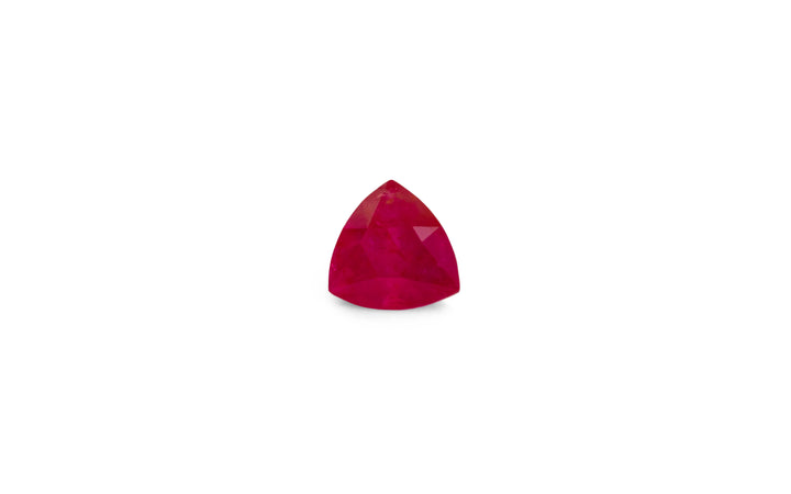 A trillion cut Burmese red ruby gemstone is displayed on a white background.