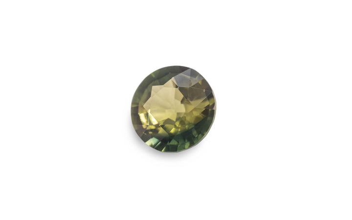 A round brilliant cut green Australian sapphire gemstone is displayed on a white background.