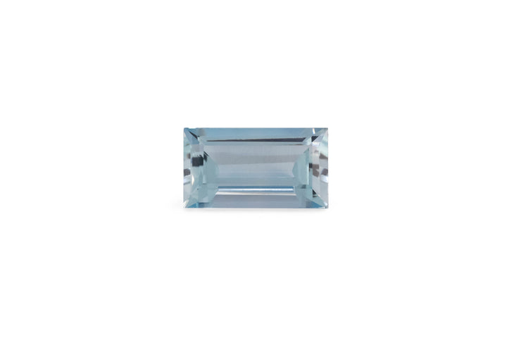 A baguette cut pale blue aquamarine gemstone is displayed on a white background.