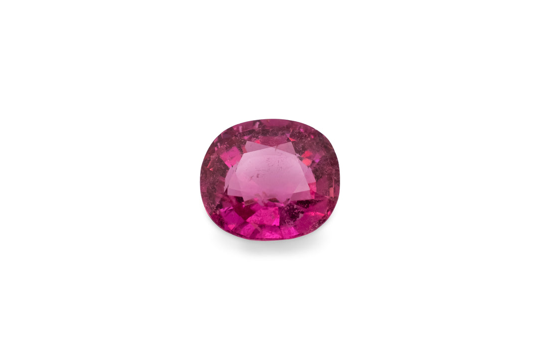 A hot pink rubellite tourmaline gemstone is displayed on a white background.