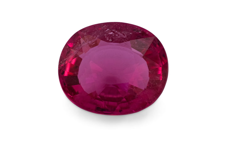 A cushion cut hot pink rubellite tourmaline gemstone is displayed on a white background.