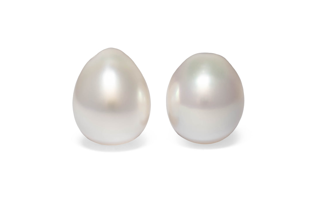 A  pair of drop pink white South Sea pearls are displayed on a white background.