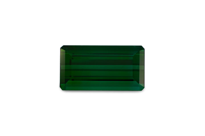 An emerald cut green tourmaline is displayed on a white background.
