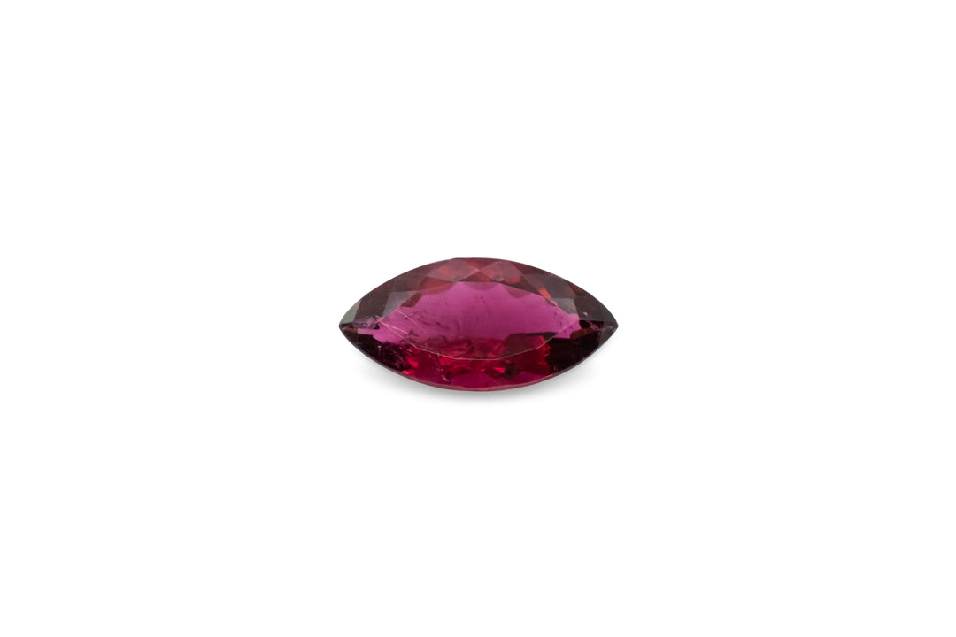 A marquise cut pink rubellite tourmaline is displayed on a white background.
