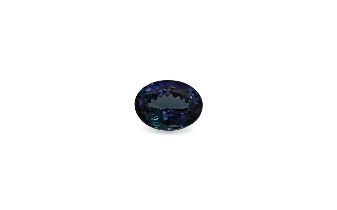 An oval cut bi-colour purple/blue and teal mermaid tanzanite gemstone is displayed on a white background.