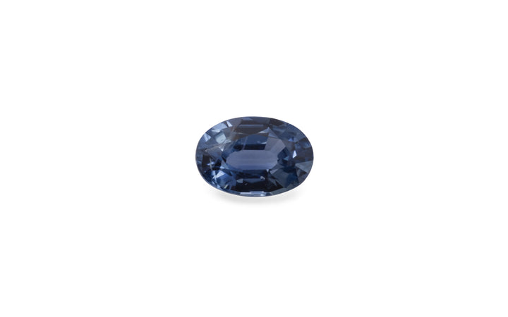 An oval cut blue ceylon sapphire gemstone is displayed on a white background.