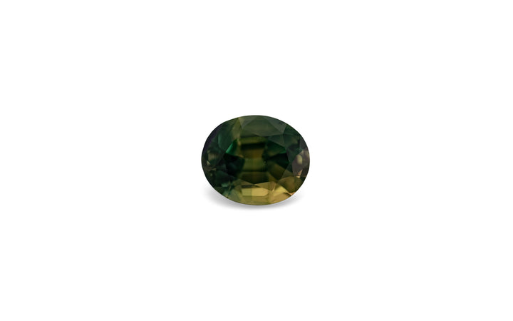 An oval cut green with zones of yellow Australian parti sapphire gemstone is displayed on a white background.