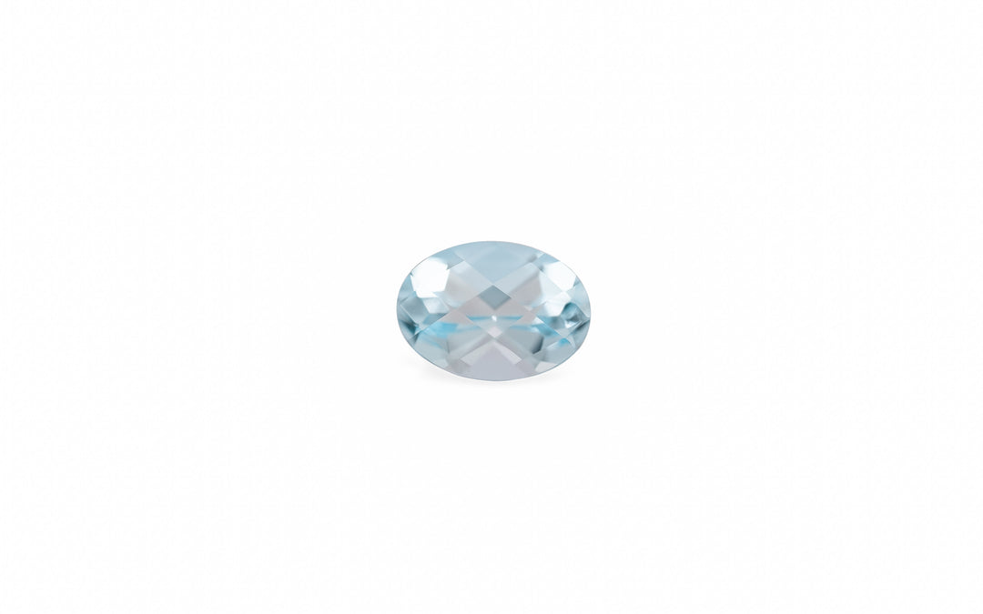 An oval cut pale  blue aquamarine gemstone is displayed on a white background.