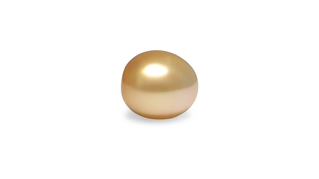 An oval shape golden South Sea pearl is displayed on a white background.