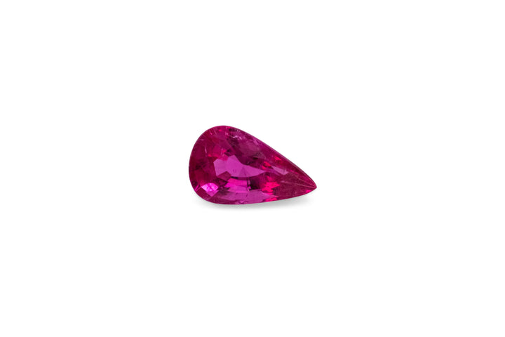 A pear cut hot pink rubellite tourmaline is displayed on a white background.