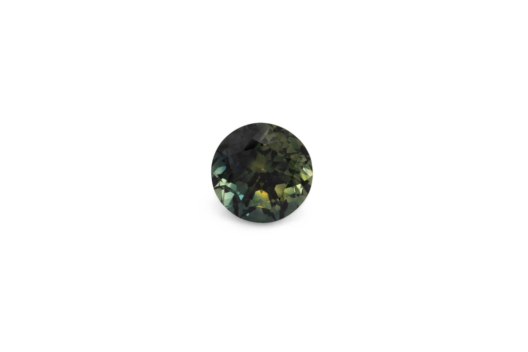 A round brilliant cut blue green Australian sapphire is displayed on a white background.