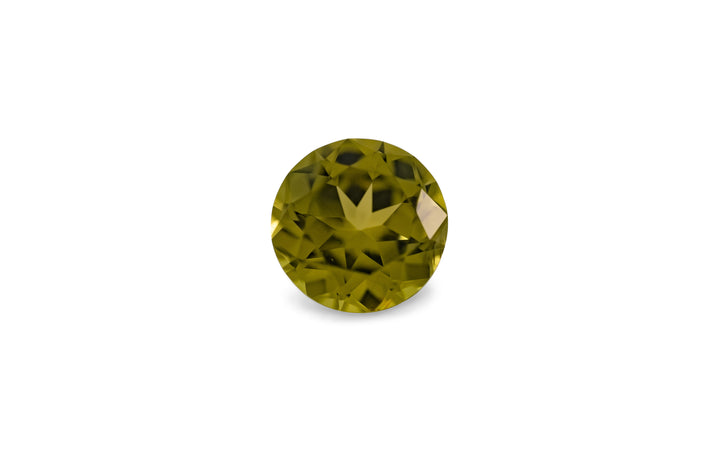 A round brilliant cut green Australian sapphire gemstone is displayed on a white background. 