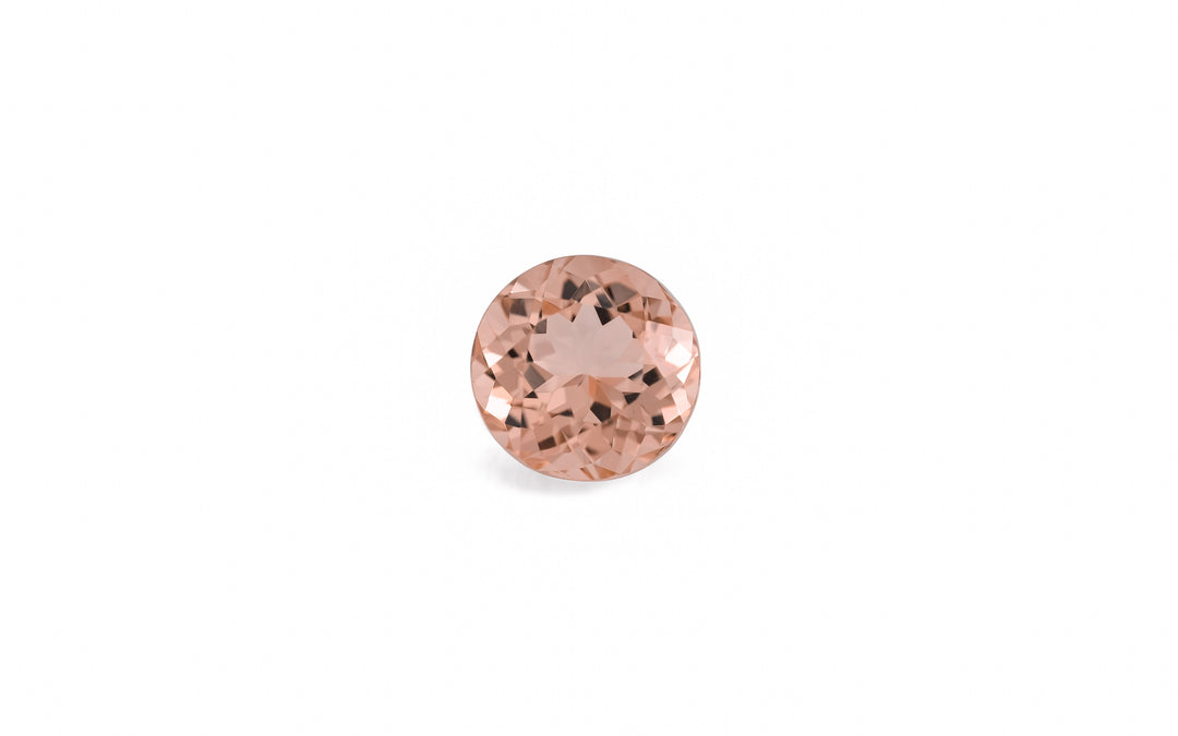 A round cut morganite gemstone is displayed on a white background.