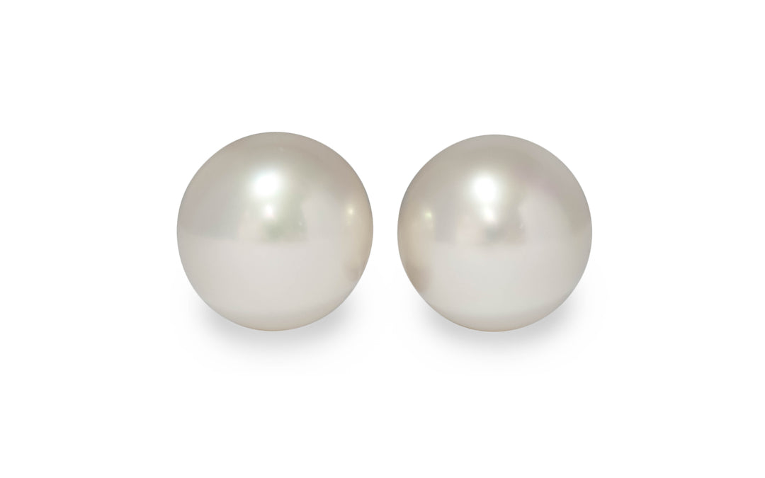 A pair of pink/silver/white South Sea pearls are displayed on a white background.
