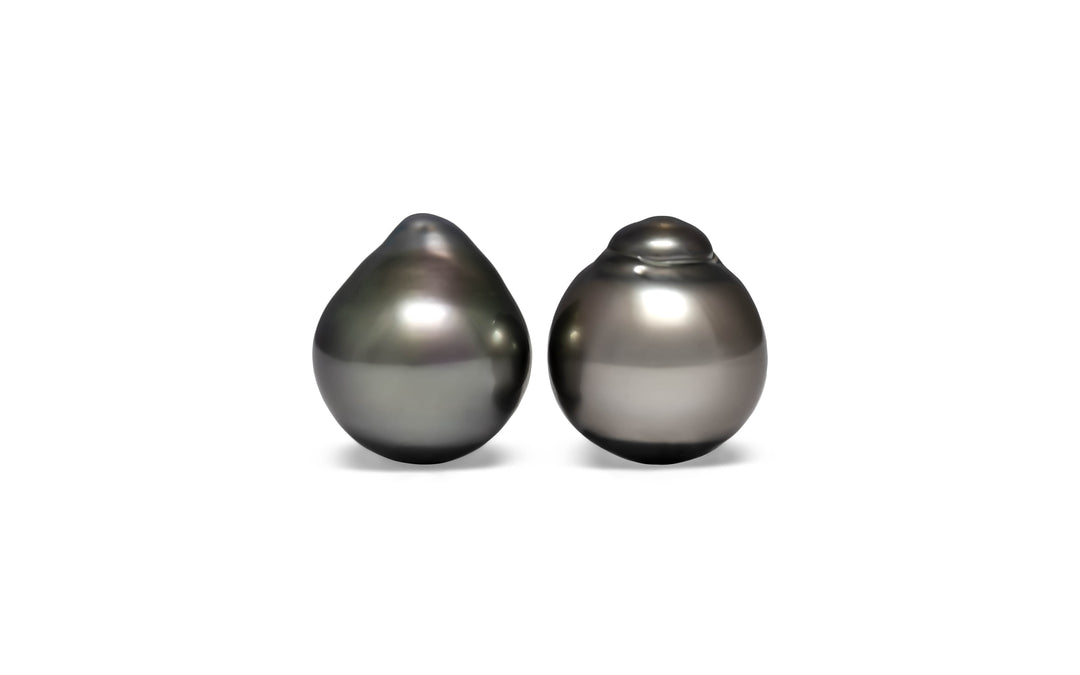 A pair of semi baroque silver green Tahitian pearls are displayed on a white background.