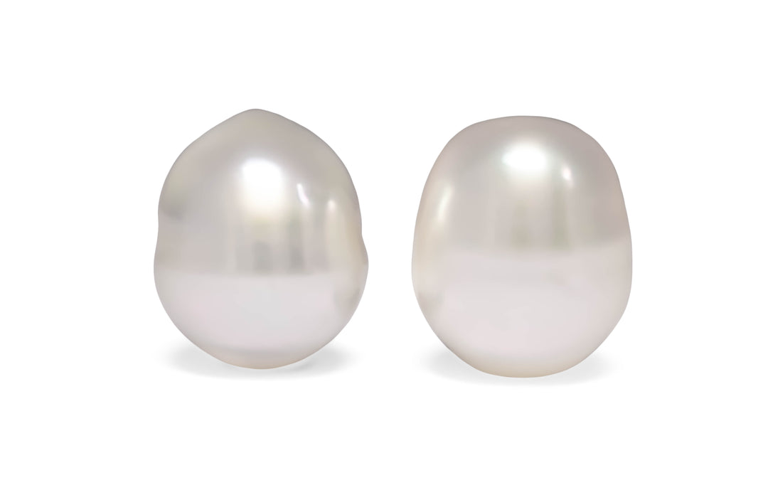 A pair of semi baroque white South Sea pearls are displayed on a white background.