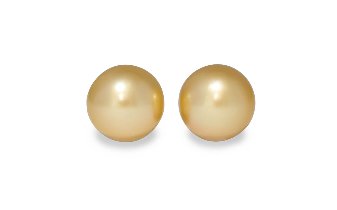A semi round shape golden South Sea pearls is displayed on a white background.