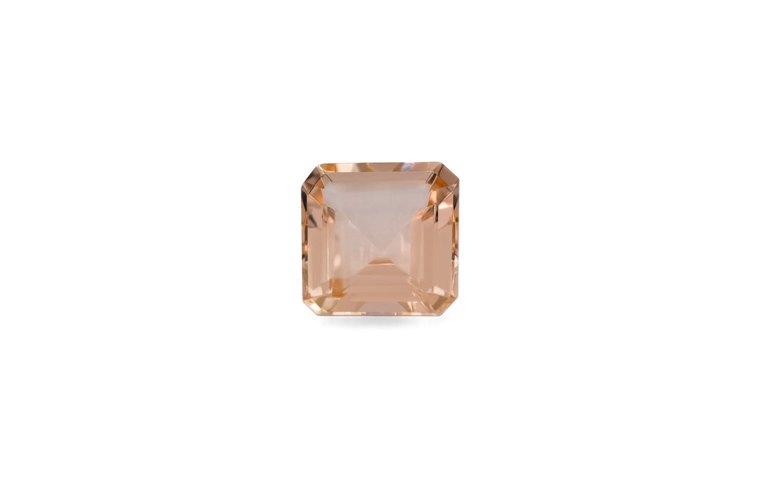 A square emerald cut peach morganite gemstone is displayed on a white background. 